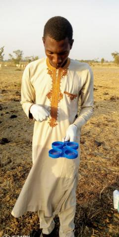 Abdulkadir Musa Mohammed collecting milk samples from communities