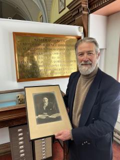 Donald Jamieson with photograph of great uncle, Professor E. B. Jamieson