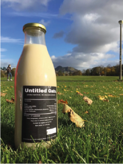 Untitled Oats plant based milk in glass bottle on grass