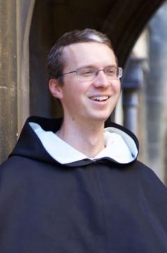 A man in traditional catholic robes smiling 