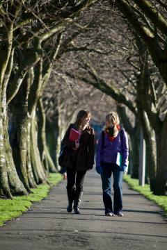 Two females walking on park path