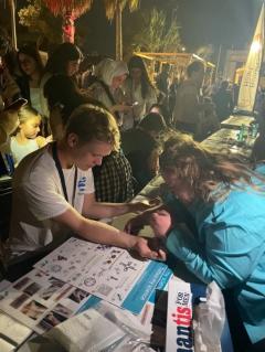 member of the public getting a tattoo at PE event