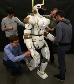 Photo of PhD students and researchers working on NASA's Valkyrie robot