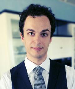 Photo of Michele Ciampi showing head and shoulders, wearing a white shirt, black waistcoat and grey and black tie.