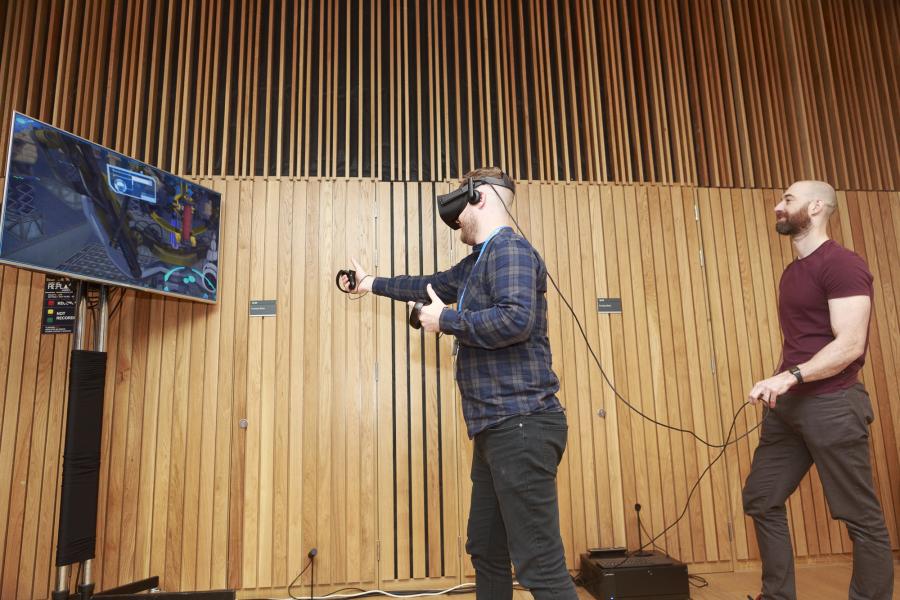 Man playing virtual reality game in Bayes Centre