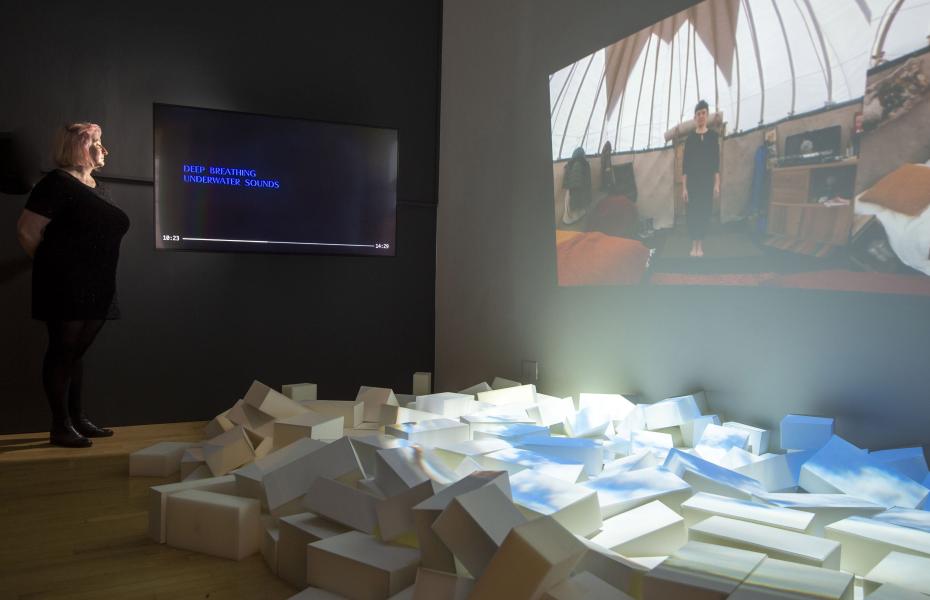 A person looks at a screen showing a piece of art by artist Jenny Hogarth