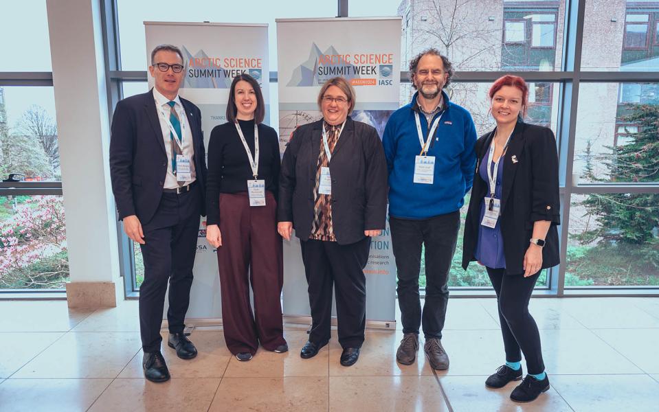 Organising committee of Arctic Science Week in front of banners