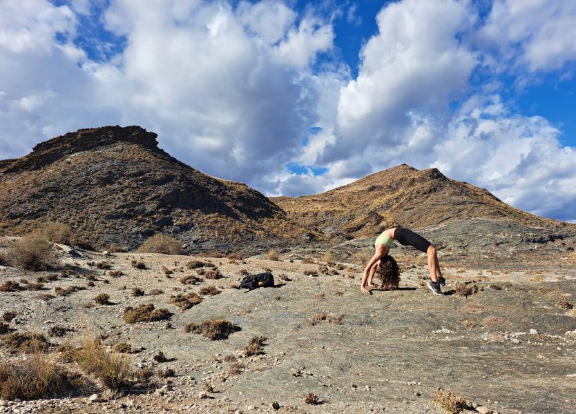 Anu Abicht doing yoga in a mountainous landscape