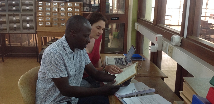 Dr Emma Wild-Wood and research assistant George Mpanga working in the archives at Makerere University, Uganda