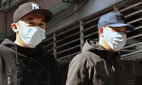 Two men walking and wearing face masks